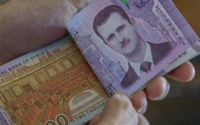 Report: Syrian Central Bank Devalues Local Currency by Nearly 50%